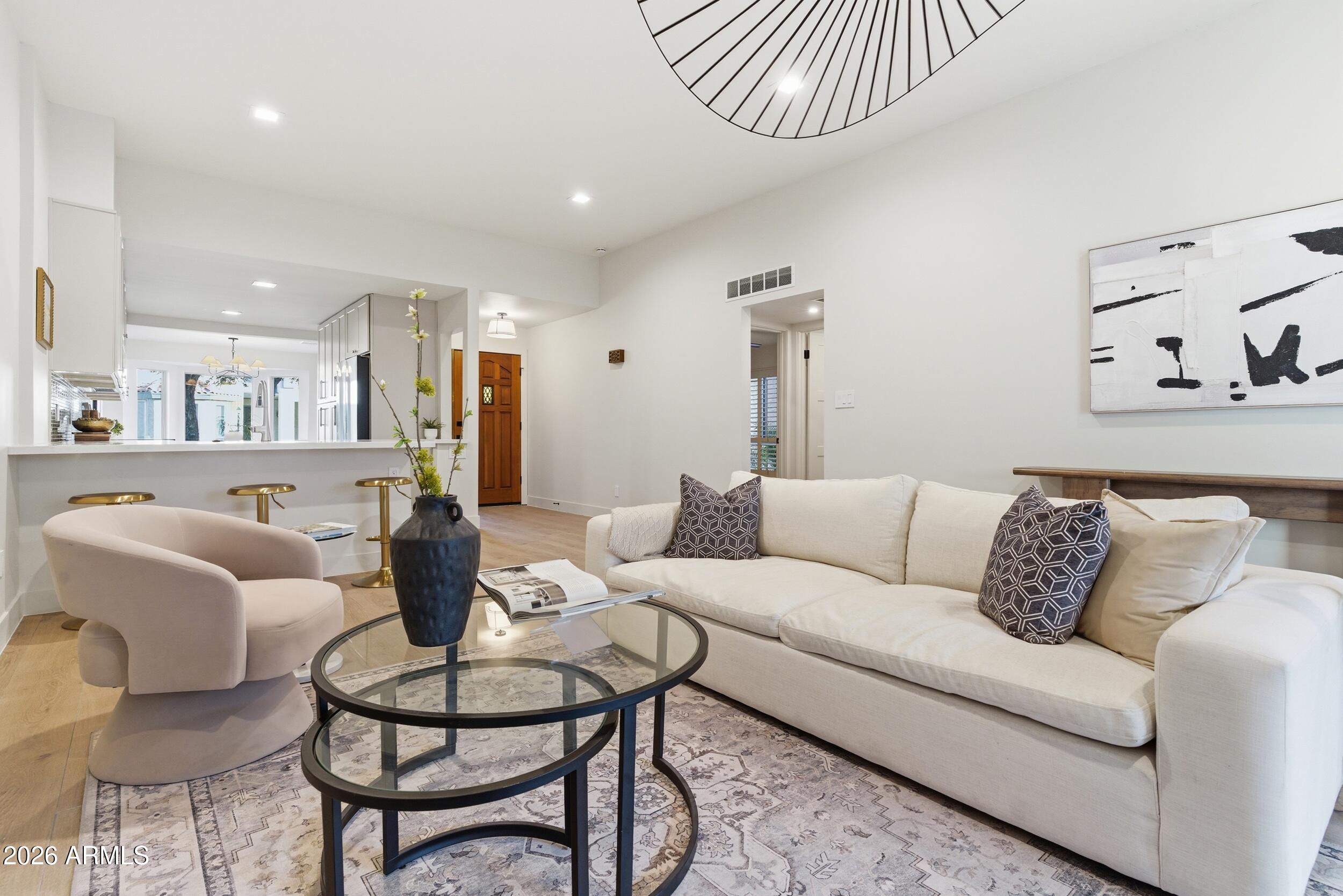 a living room with furniture and a wooden floor