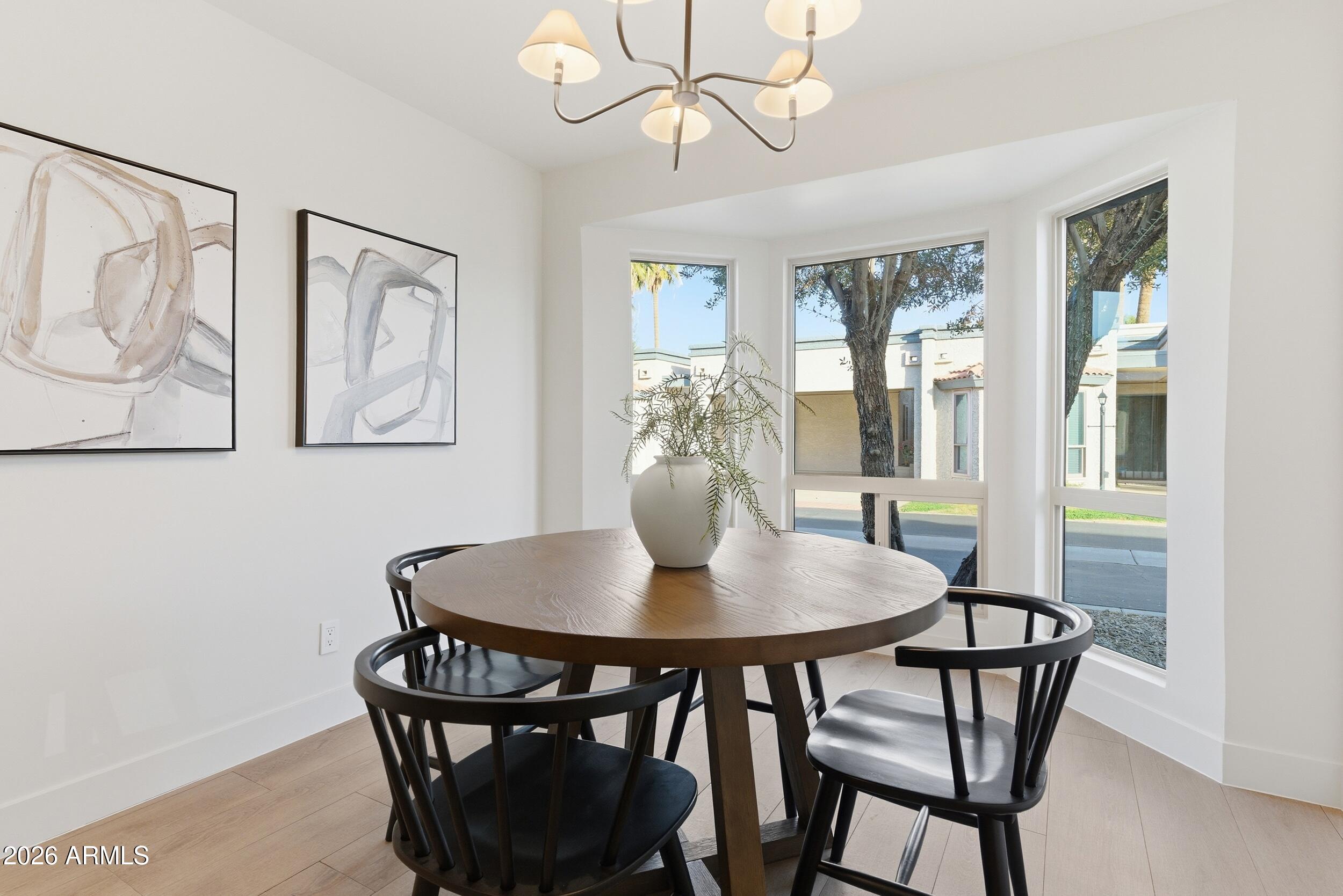 3415 North 36th Street, Unit 3 Phoenix, AZ 85018 - Photo 12 of 33 a view of a dining room with furniture window and wooden floor