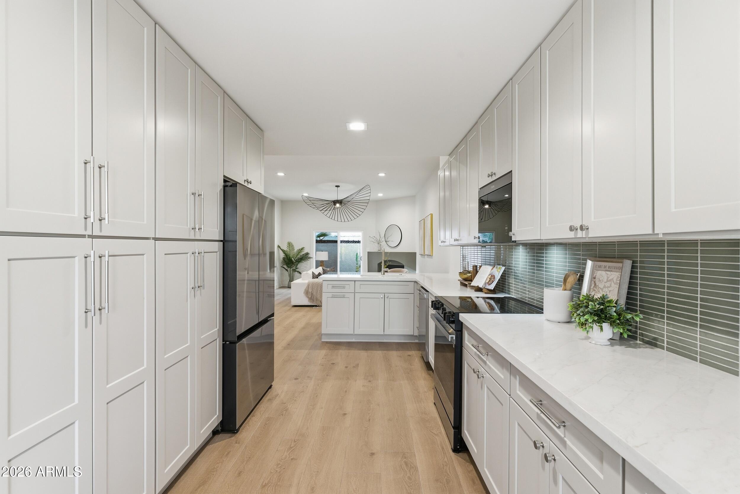 3415 North 36th Street, Unit 3 Phoenix, AZ 85018 - Photo 13 of 33 a kitchen with white cabinets and stainless steel appliances