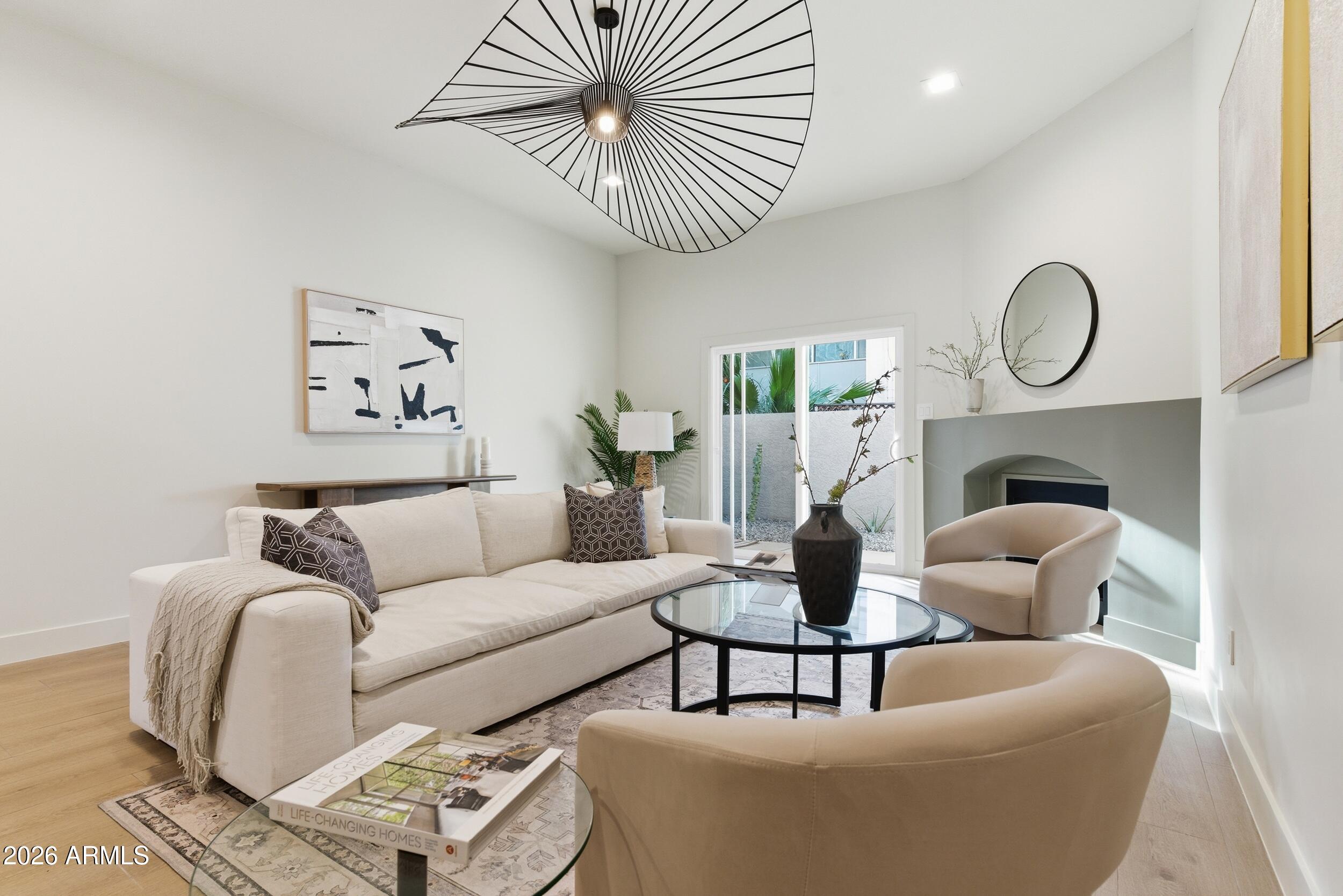 3415 North 36th Street, Unit 3 Phoenix, AZ 85018 - Photo 14 of 33 a living room with furniture a table and a fireplace