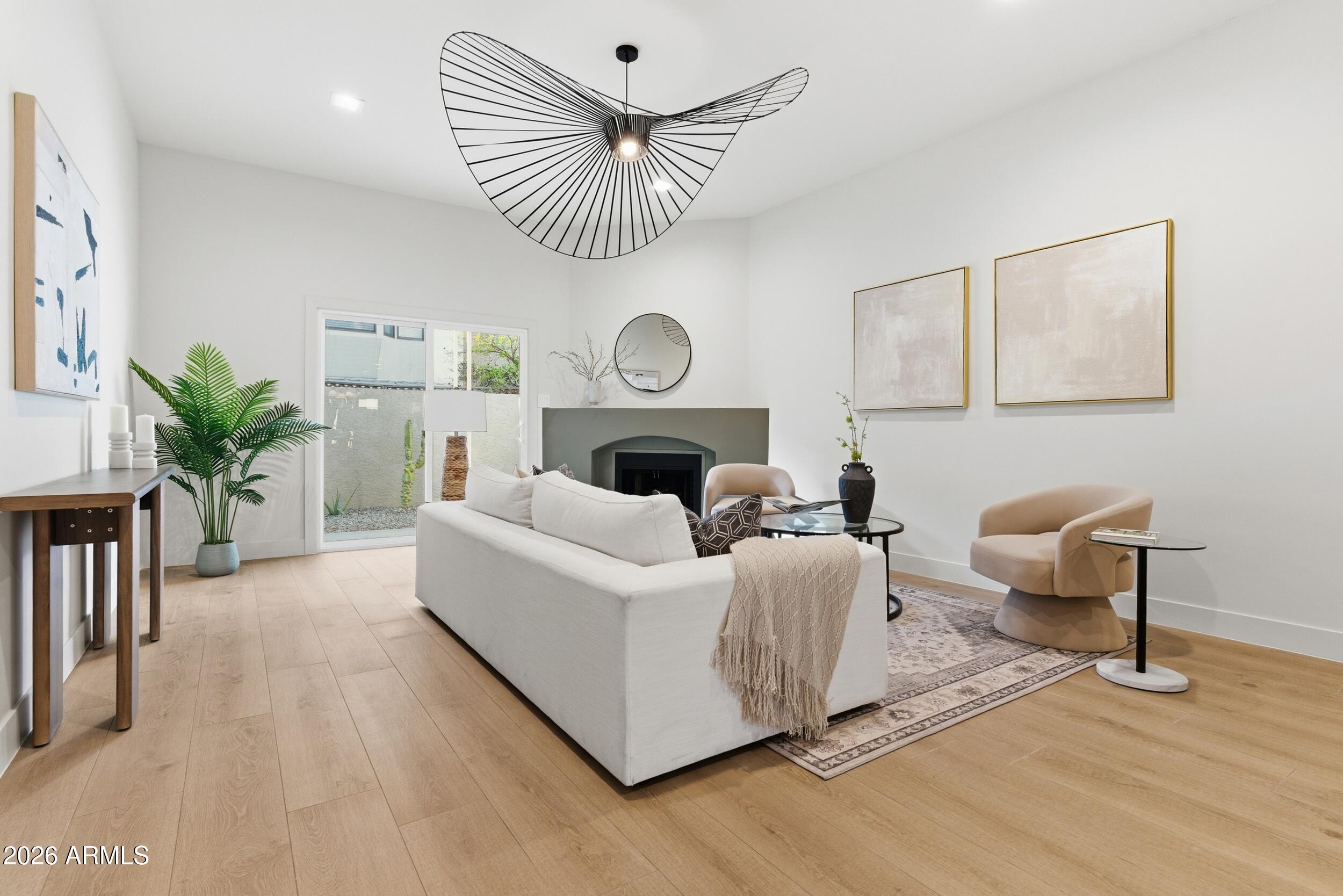 3415 North 36th Street, Unit 3 Phoenix, AZ 85018 - Photo 15 of 33 a living room with furniture and a clock