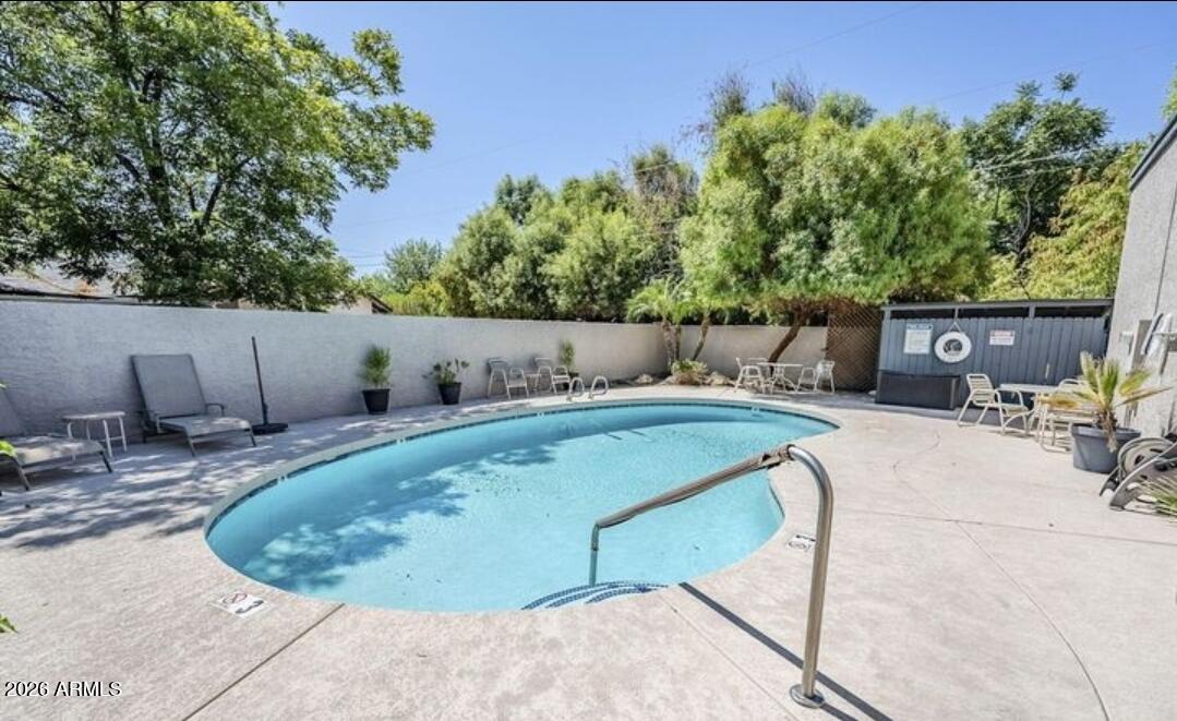 3415 North 36th Street, Unit 3 Phoenix, AZ 85018 - Photo 31 of 33 a view of a swimming pool with a patio and a yard