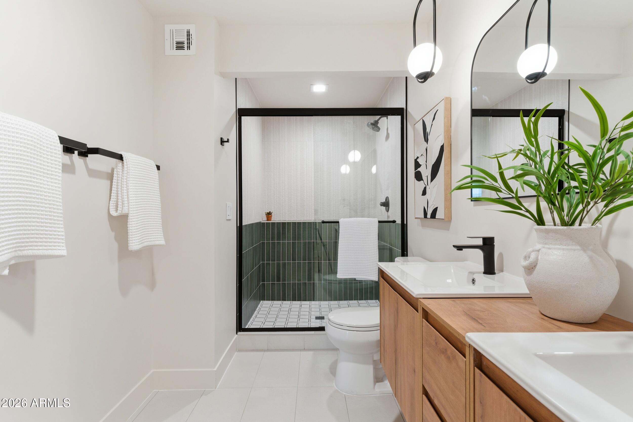 3415 North 36th Street, Unit 3 Phoenix, AZ 85018 - Photo 6 of 33 a bathroom with a granite countertop sink a toilet and shower