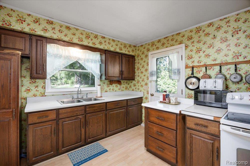 59380 10 Mile Road South Lyon, MI 48178 - Photo 15 of 53 Wood-finish cabinetry paired with white countertops