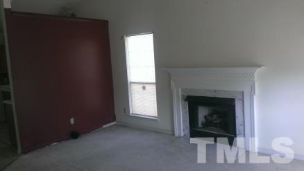 3909 Old Coach Road Raleigh, NC 27616 - Photo 5 of 10 a view of a livingroom with a fireplace