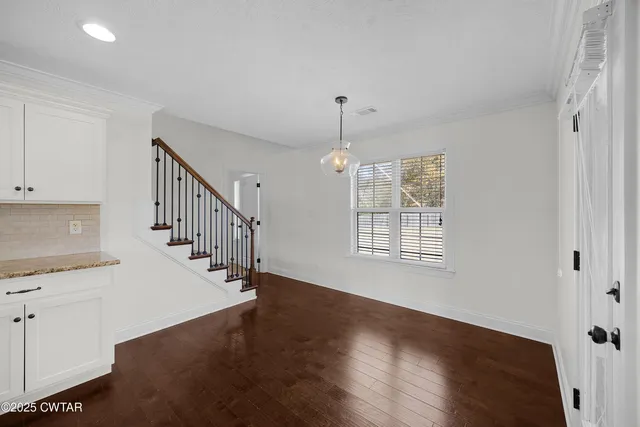 a view of entryway and hall with wooden floor