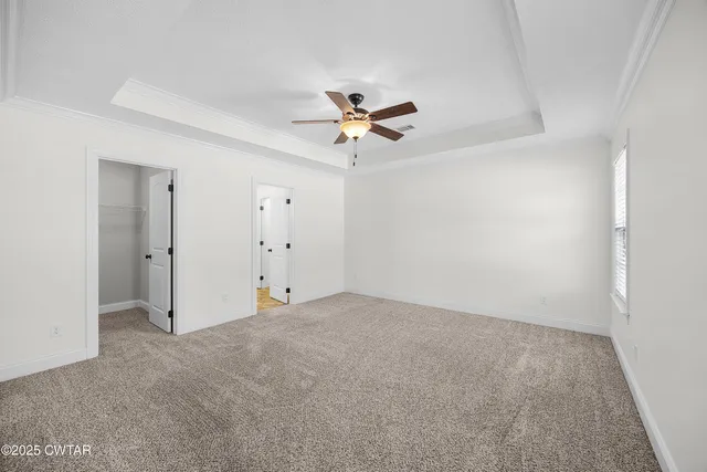 an empty room with fan and a ceiling fan