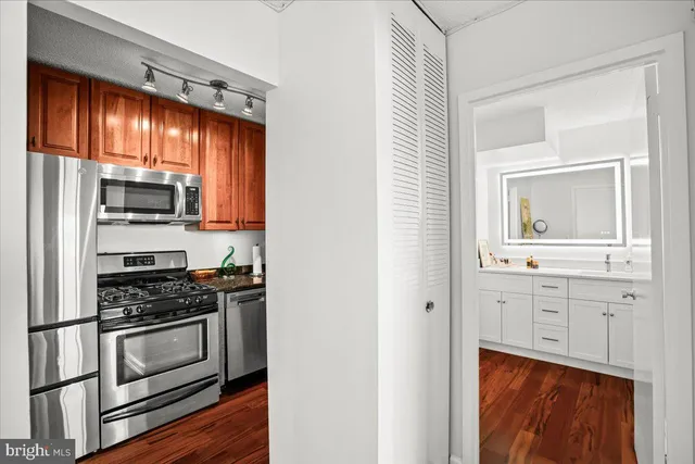 a kitchen with white cabinets and appliances