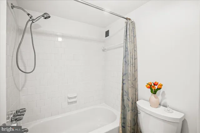 a white bath tub sitting next to a white toilet