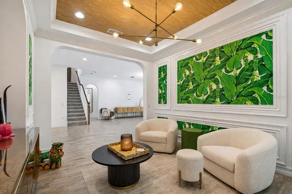 a living room with furniture and a potted plant