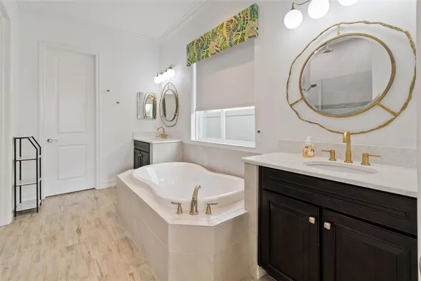 a bathroom with a sink vanity and a mirror