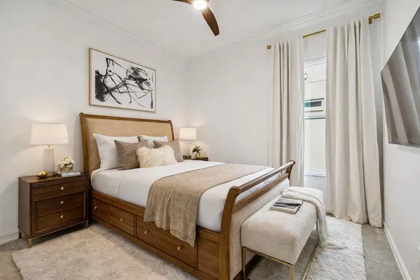 a bedroom with a bed and a window