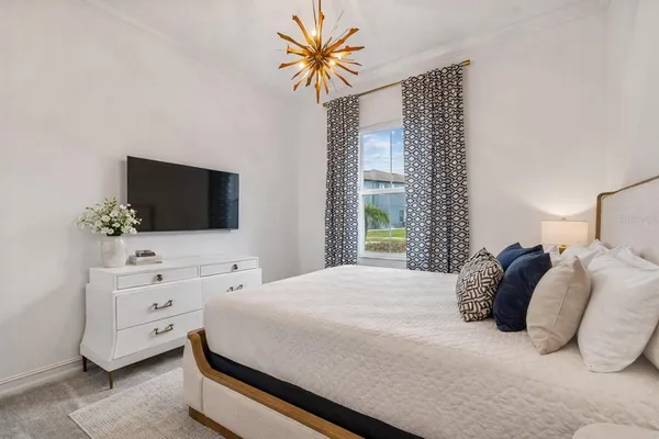 a bedroom with a bed and a flat screen tv