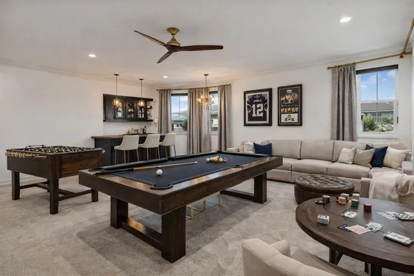 a living room with furniture a flat screen tv and a window