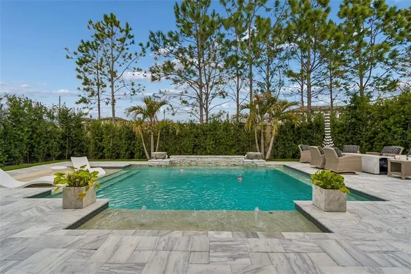 a view of a backyard with sitting area