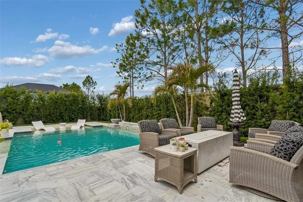 a view of a patio with couches and a big yard