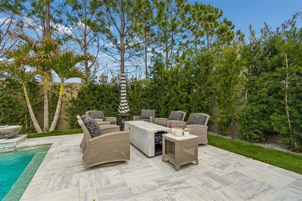a backyard of a house with fountain table and chairs