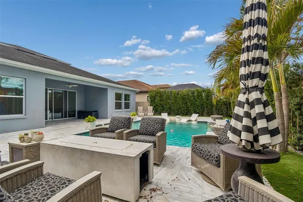a view of a house with backyard and sitting area