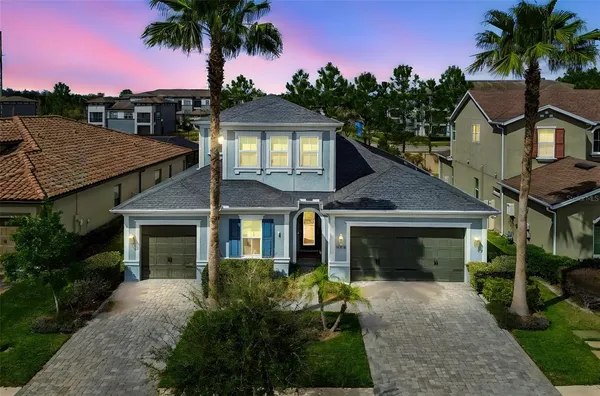 a front view of a house with a garden and yard