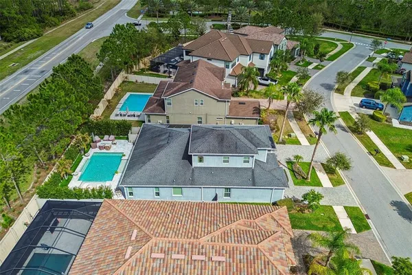 an aerial view of a house with a yard and greenery