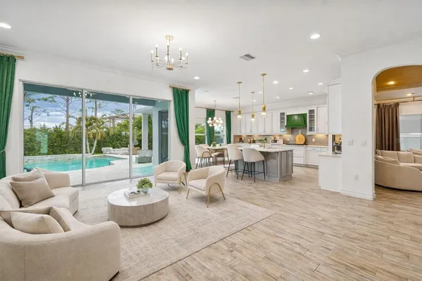a living room with fireplace furniture and a large window