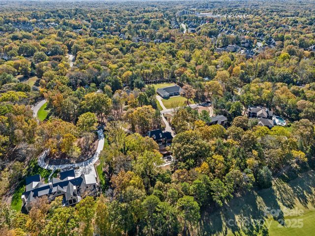 an aerial view of a houses with a city
