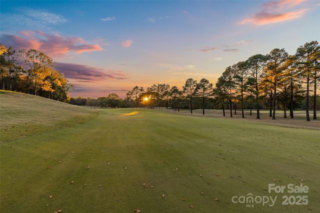 a view of a house with a yard and tree