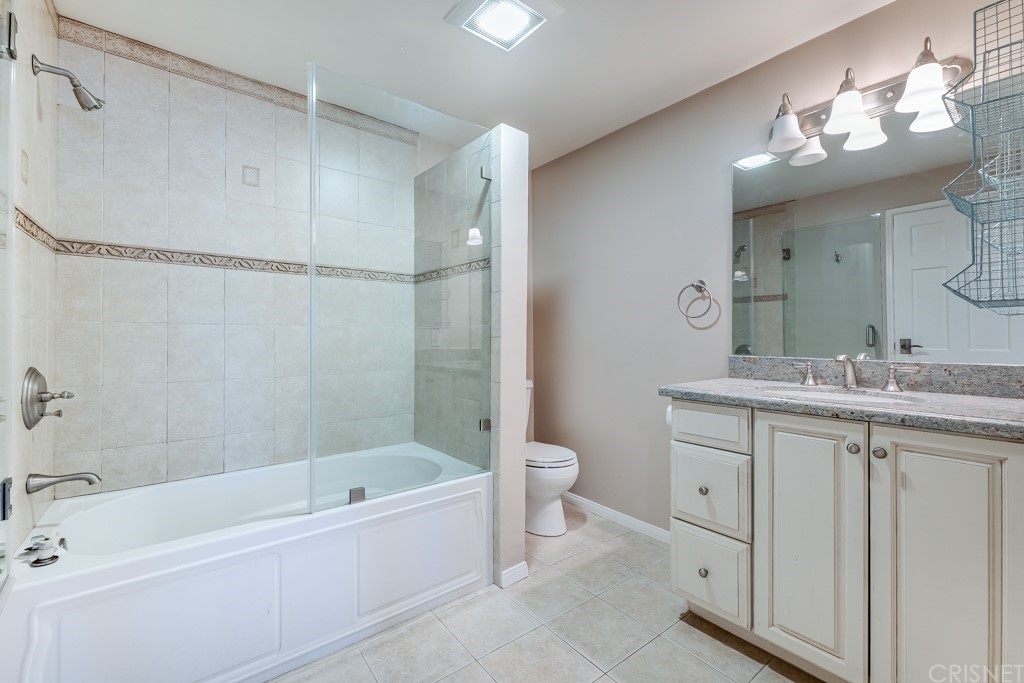 150 Saddlebow Road Bell Canyon, CA 91307 - Photo 16 of 37 a bathroom with a granite countertop sink a toilet mirror and bathtub