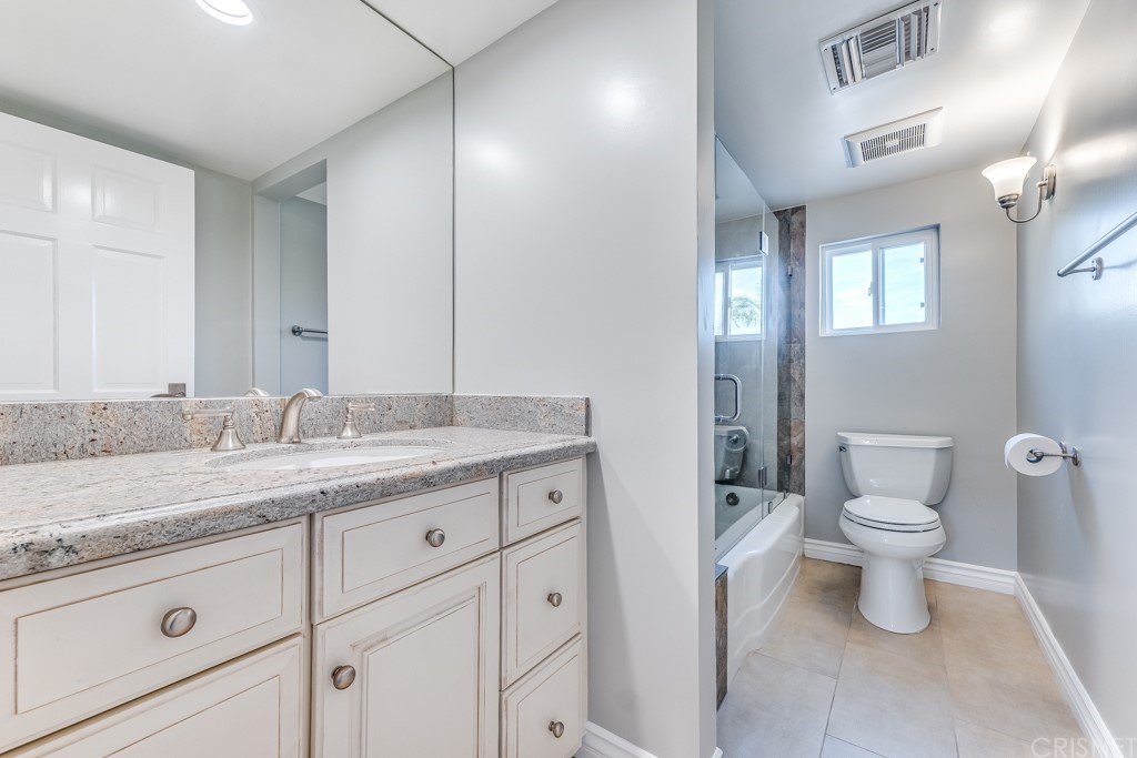 150 Saddlebow Road Bell Canyon, CA 91307 - Photo 17 of 37 a bathroom with a granite countertop sink a toilet and a mirror