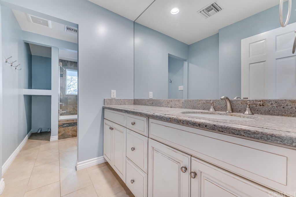 150 Saddlebow Road Bell Canyon, CA 91307 - Photo 18 of 37 a spacious bathroom with a granite countertop sink and a mirror