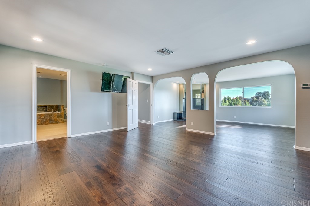 150 Saddlebow Road Bell Canyon, CA 91307 - Photo 23 of 37 a view of an empty room with wooden floor and a window