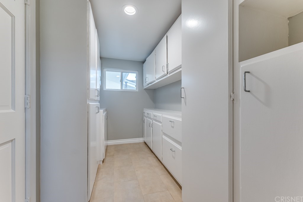 150 Saddlebow Road Bell Canyon, CA 91307 - Photo 26 of 37 a kitchen with white cabinets and white appliances