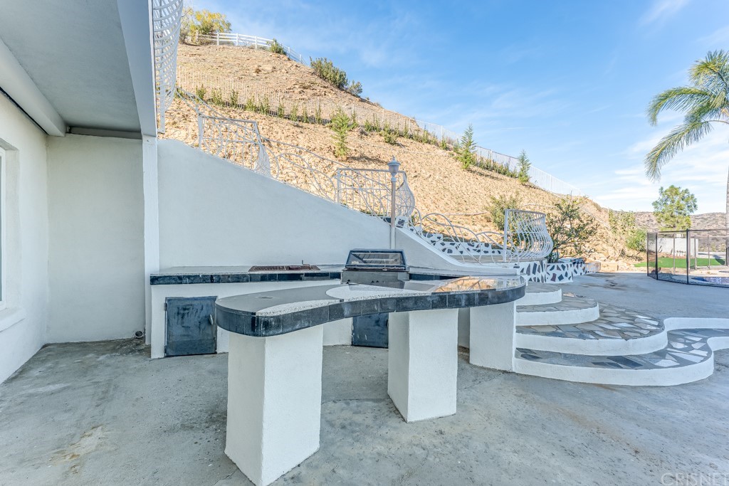 150 Saddlebow Road Bell Canyon, CA 91307 - Photo 34 of 37 a view of a kitchen with a sink and a stove