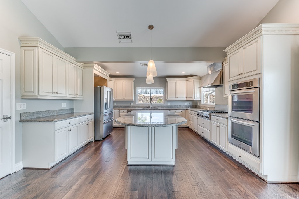 150 Saddlebow Road Bell Canyon, CA 91307 - Photo 6 of 37 a kitchen with stainless steel appliances a white cabinets and stove top oven