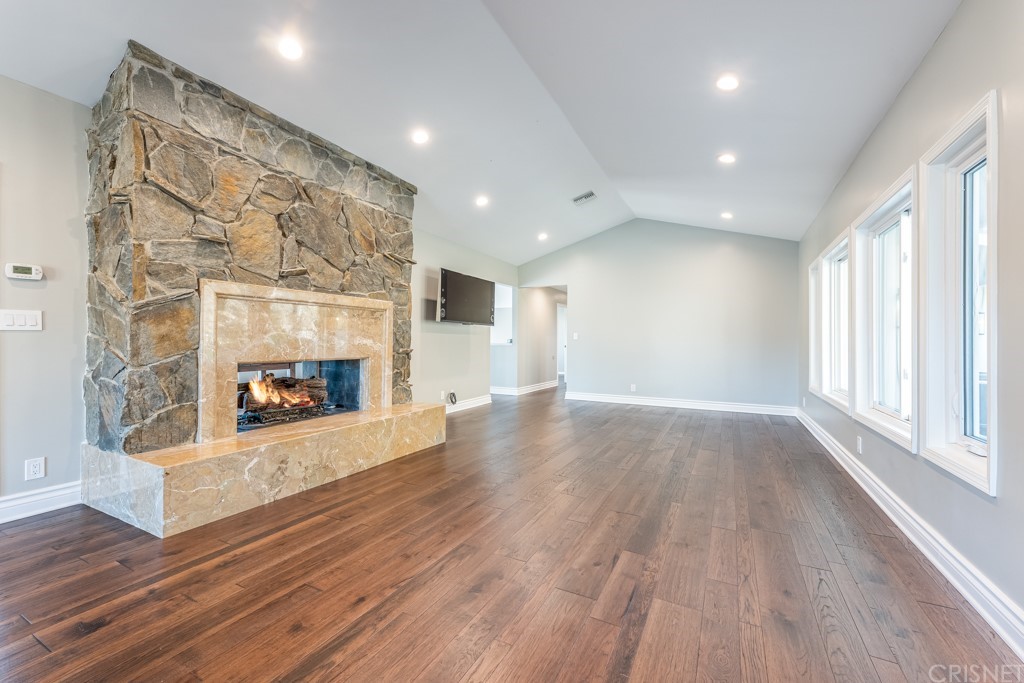 150 Saddlebow Road Bell Canyon, CA 91307 - Photo 8 of 37 a view of a livingroom with wooden floor and a fireplace