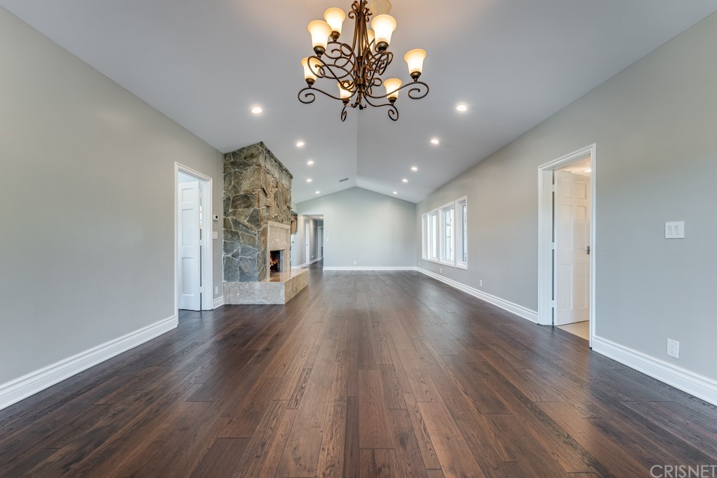 150 Saddlebow Road Bell Canyon, CA 91307 - Photo 9 of 37 a view of a room with wooden floor chandelier and windows