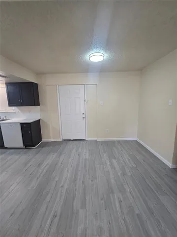 a view of kitchen with wooden floor and electronic appliances