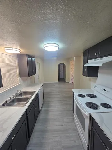 a kitchen that has a sink and a stove