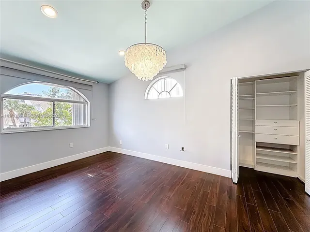 a view of a room with wooden floor and window