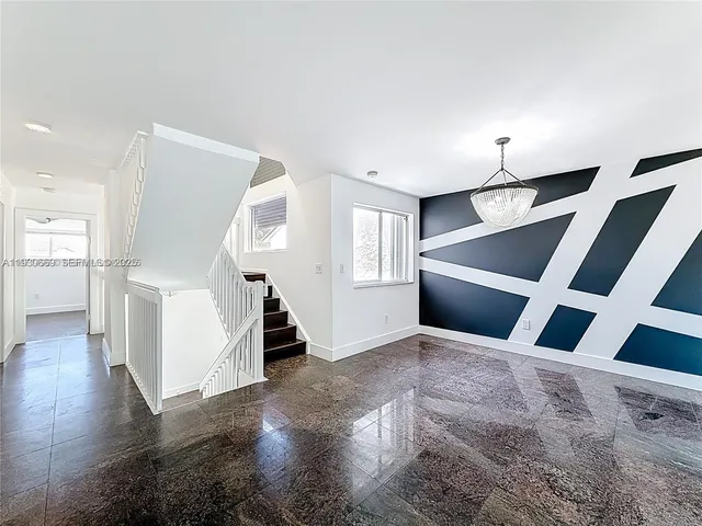 a view of a livingroom with wooden floor and stairs