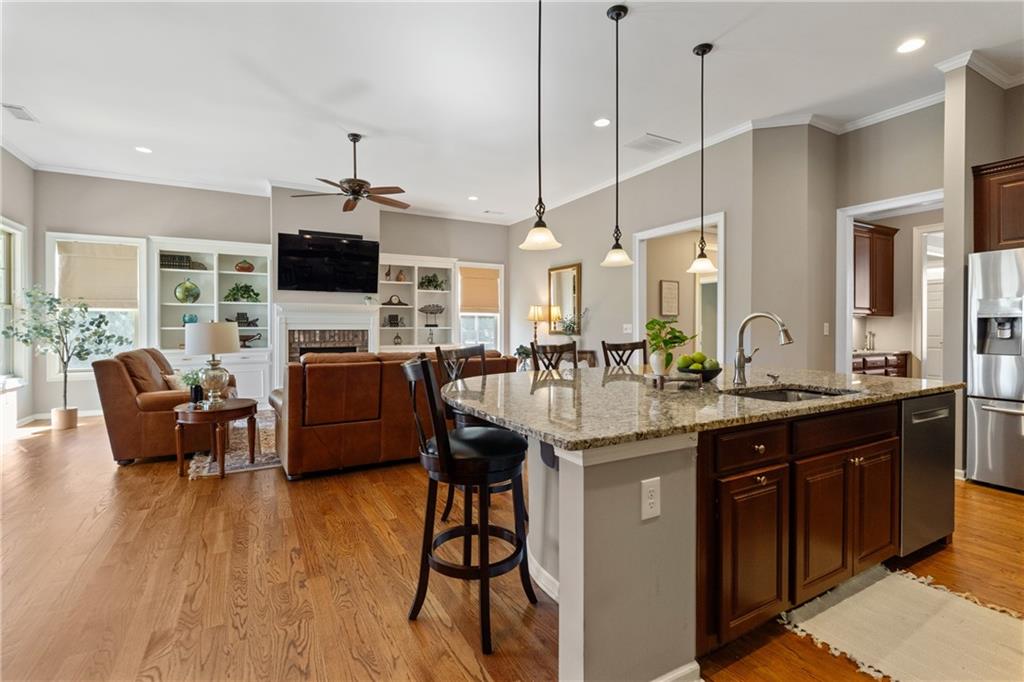 319 Laurel Lookout Hills Canton, GA 30114 - Photo 18 of 80 a kitchen with stainless steel appliances granite countertop a sink a stove and a wooden floors