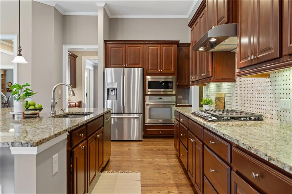 319 Laurel Lookout Hills Canton, GA 30114 - Photo 19 of 80 a kitchen with stainless steel appliances granite countertop a sink stove and refrigerator