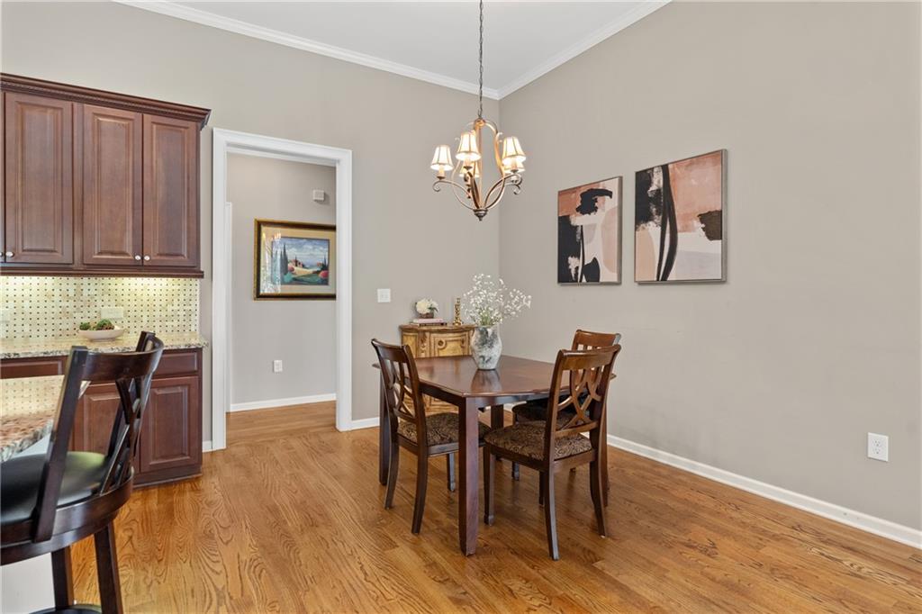 319 Laurel Lookout Hills Canton, GA 30114 - Photo 24 of 80 a view of a dining room with furniture and wooden floor