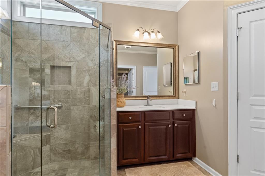 319 Laurel Lookout Hills Canton, GA 30114 - Photo 30 of 80 a bathroom with a granite countertop sink a mirror and a shower