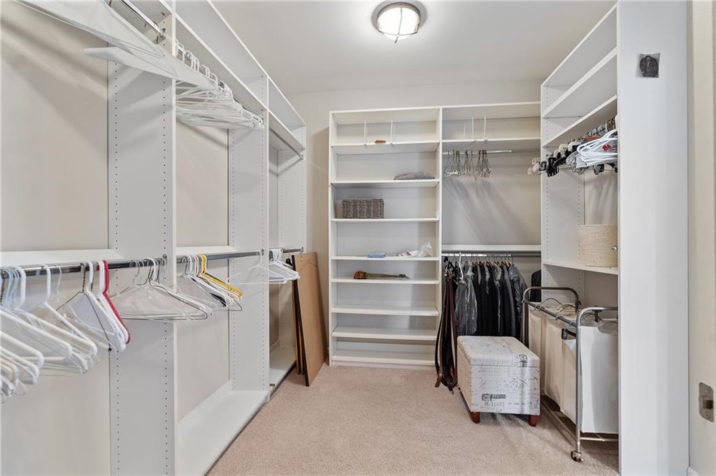 319 Laurel Lookout Hills Canton, GA 30114 - Photo 41 of 80 a view of walk in closet with clothes and shoes
