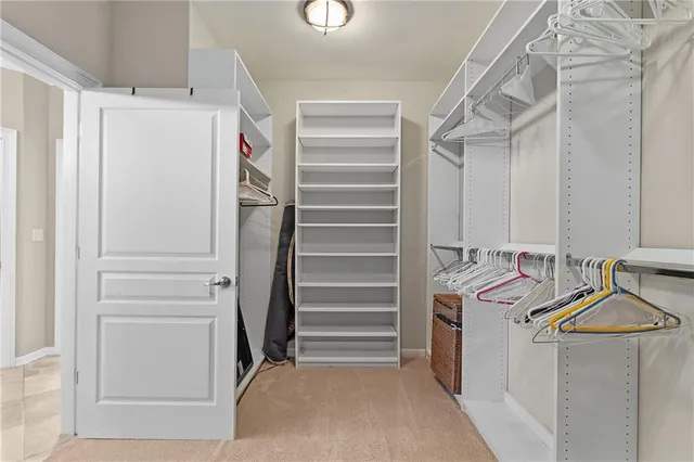 a living room with lots of furniture a rug and a chandelier