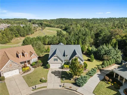 a dining room with furniture a chandelier and wooden floor