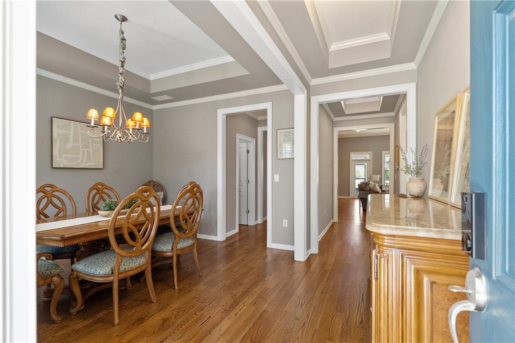 319 Laurel Lookout Hills Canton, GA 30114 - Photo 7 of 80 a dining room with furniture a chandelier and wooden floor