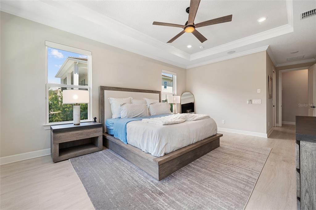 10175 Brocksport Circle Gotha, FL 34734 - Photo 18 of 54 a bedroom with a bed and a chandelier
