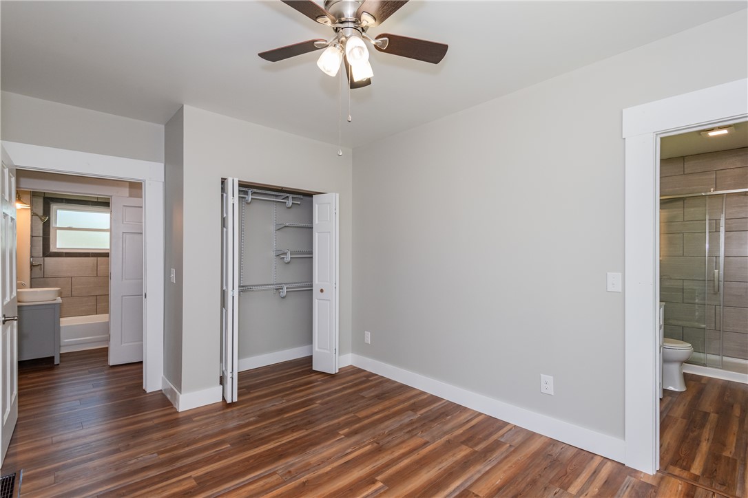 1217 Jasper Road Xenia, OH 45385 - Photo 37 of 62 This spacious bedroom features warm wood flooring and a modern ceiling fan, offering comfort and style.